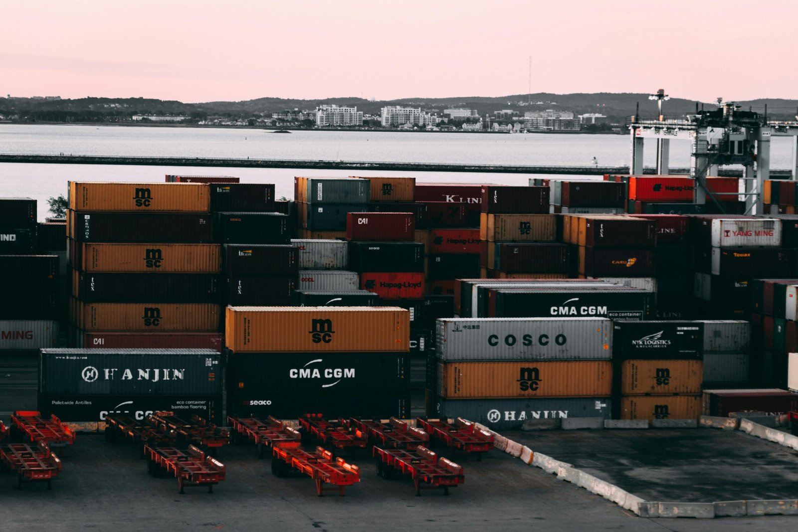 An Evergreen container ship loading at the Port of Baltimore during daytime.
